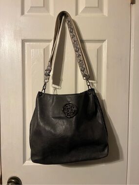Black Women's Shoulder Bag with Ornamental Medallion and Decorative Strap